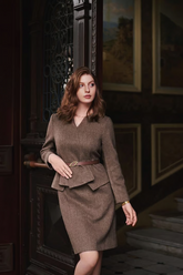 a lady wears a dark brown top with amatching midi skirt